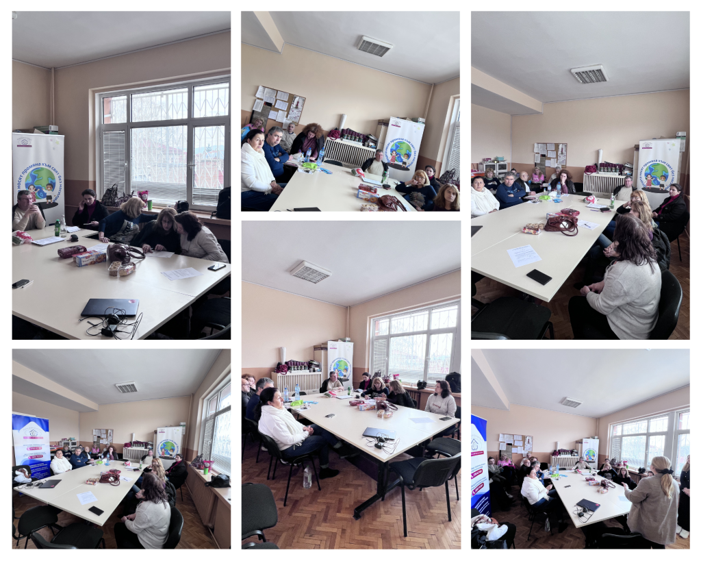 Group of adults seated around a long conference table in a bright room, discussing papers and notes on the table.