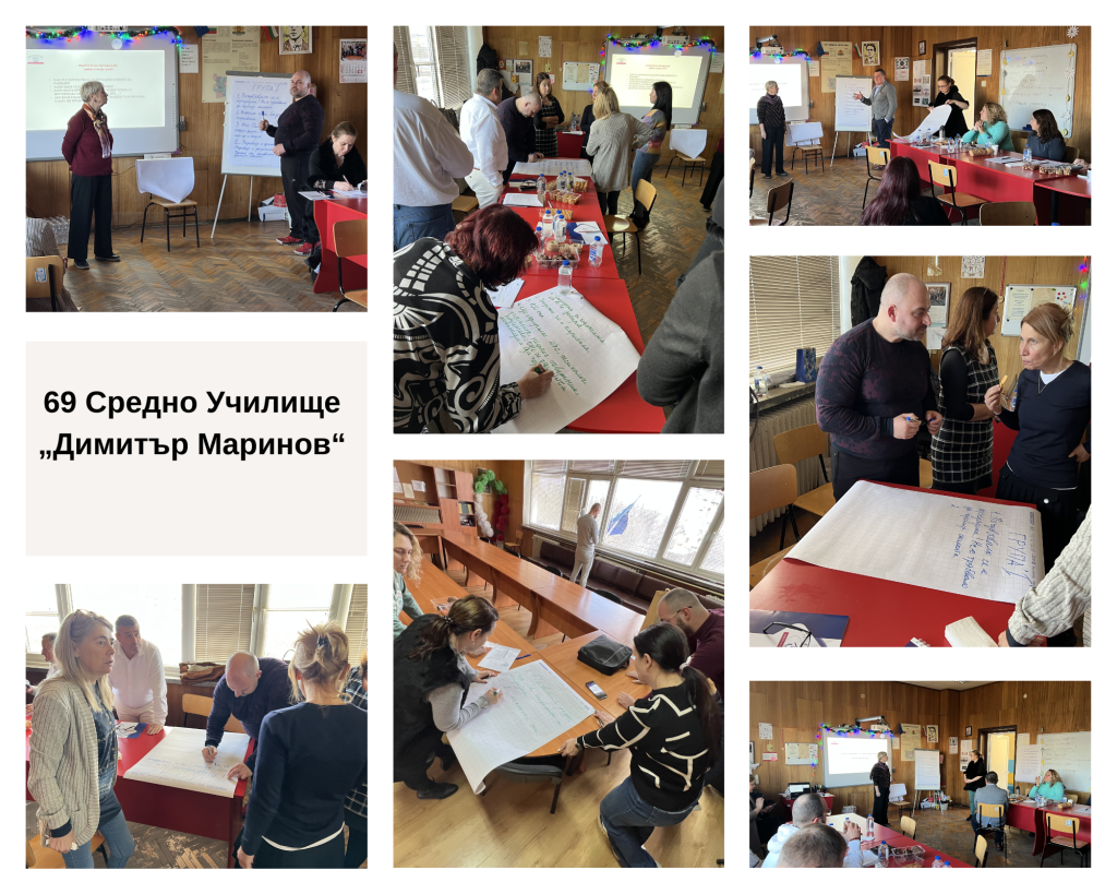 Adults seated at red-covered tables in a classroom workshop, writing on large sheets and discussing a presentation on the wall.